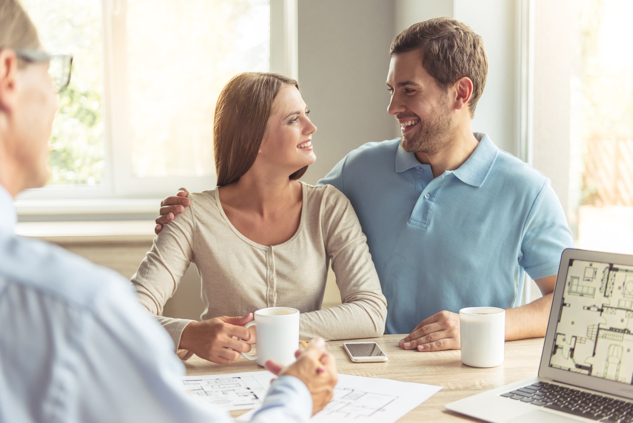 Happy couple discussing their custom home vision with Smartway Builders, illustrating collaborative planning.