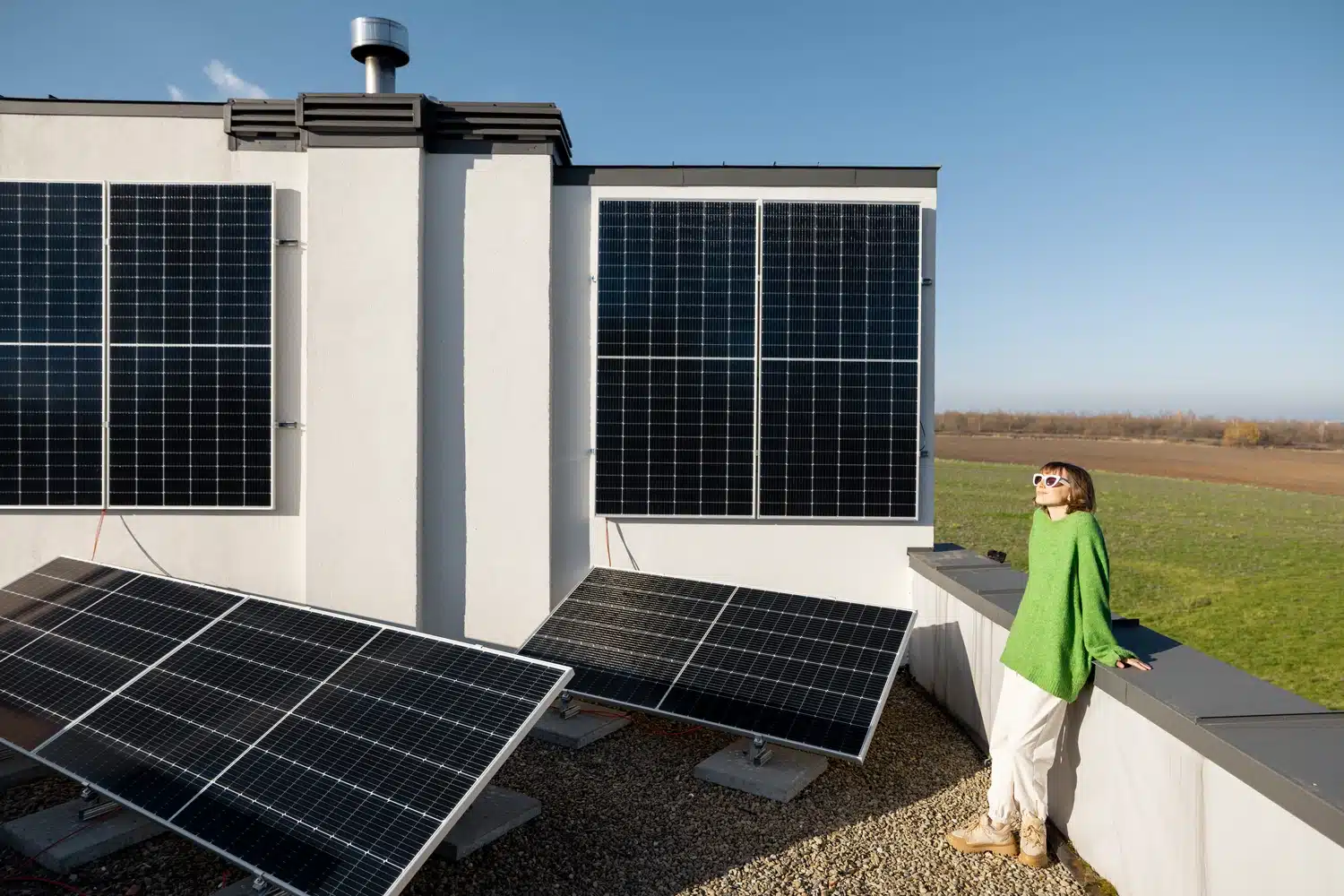 Homeowner enjoying the benefits of sustainable energy from solar panels installed by Smartway Builders.